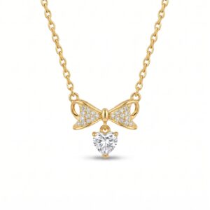 Model wearing delicate bow and heart necklace