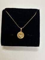Model wearing gold plated heart necklace