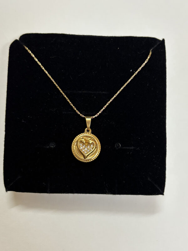 Model wearing gold plated heart necklace