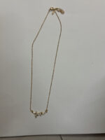 Flat lay of gold plated heart necklace on white surface
