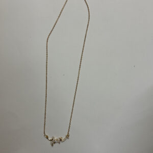 Flat lay of gold plated heart necklace on white surface