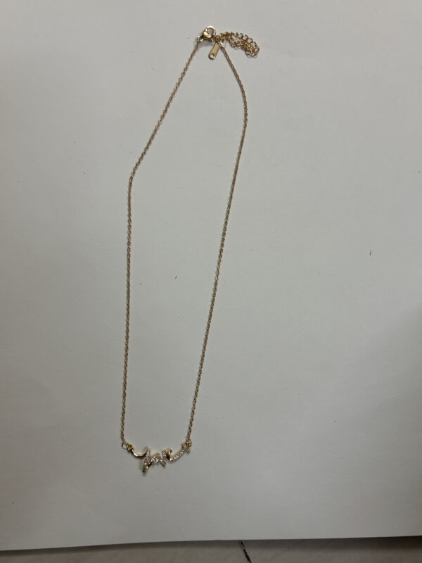 Flat lay of gold plated heart necklace on white surface