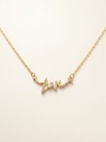 Close up detail of gold plated heart necklace with crystal pendant