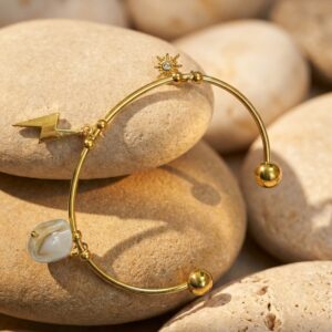 woman wearing a gold plated bracelet with celestial charms