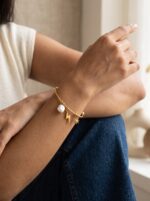 gold plated bracelet with sun and lightning charms