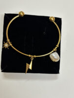 flat lay of a gold plated bracelet on black velvet