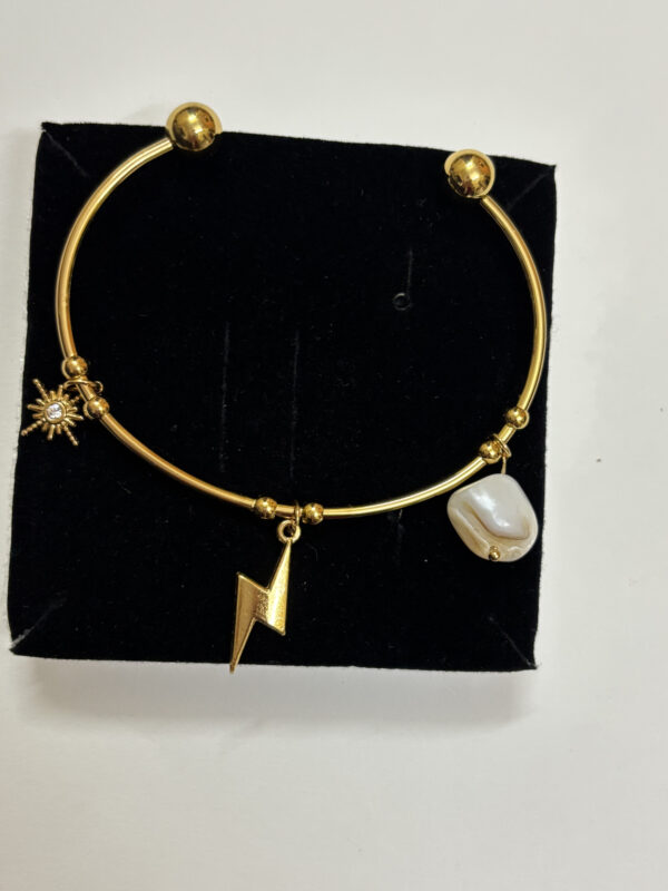 flat lay of a gold plated bracelet on black velvet