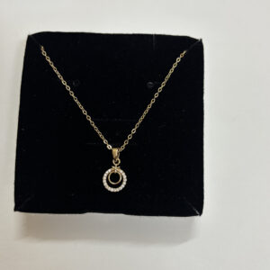 The gold plated necklace showcased on a display bust
