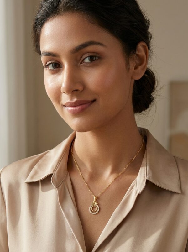 aura-circle-gold-plated-necklace-gal-4 Close up of the gold plated necklace with a circular pendant on a black stand