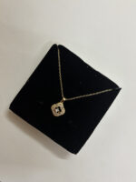 Model wearing an elegant gold plated pendant