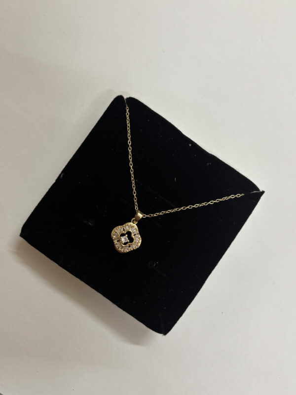 Model wearing an elegant gold plated pendant