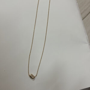 Minimalist gold plated necklace on black velvet display