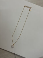 Elegant gold plated heart necklace on black velvet