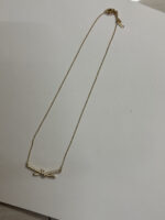 Model wearing delicate Aura Knot Golden Necklace
