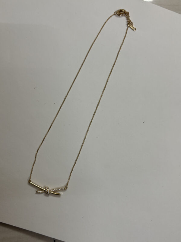 Model wearing delicate Aura Knot Golden Necklace