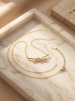 Aura Knot Golden Necklace laid flat on white surface