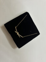 Aura Knot Golden Necklace laid flat on white surface