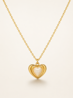 Gold plated heart necklace with mother of pearl center on black jewelry box