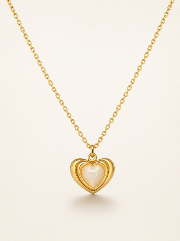 Gold plated heart necklace with mother of pearl center on black jewelry box