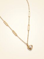 Elegant display of the Aura Pearl Heart Necklace on a mannequin bust