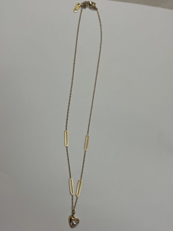 Close up of the Aura Pearl Heart Necklace inside a velvet box