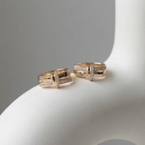 Studio shot of Radiant Gold Hoop Earrings on sculpture