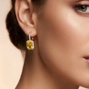 Close up of model wearing rectangular stone drop earrings