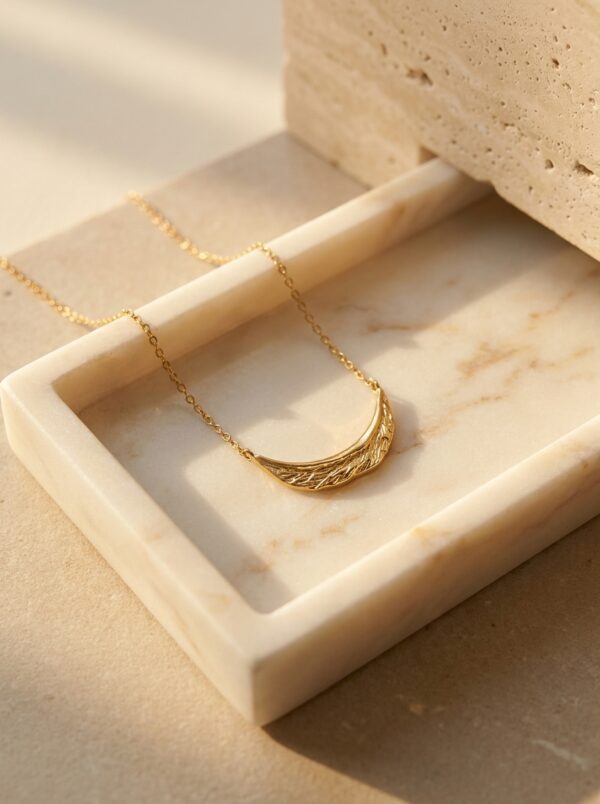 Full length view of the Crescent Moon Golden Necklace against a white background