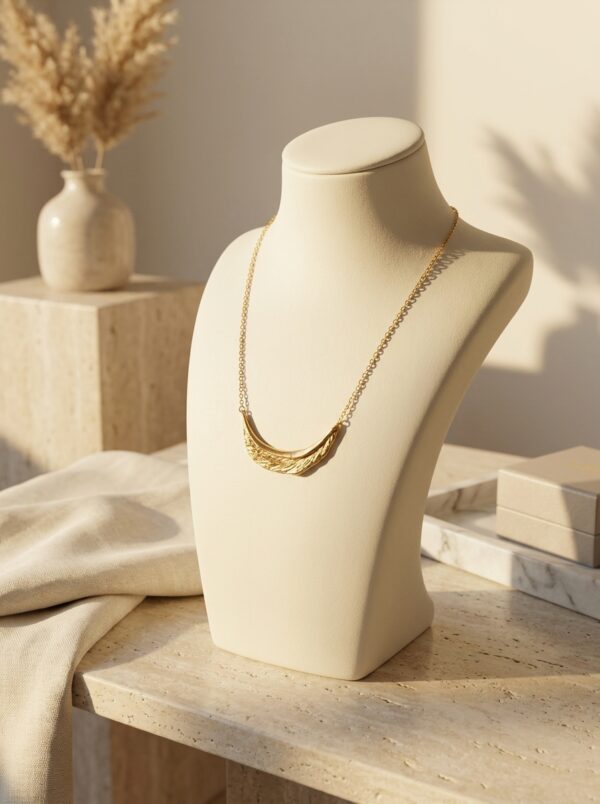 Full length view of the Crescent Moon Golden Necklace against a white background