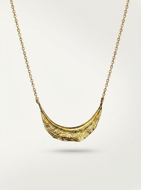 Full length view of the Crescent Moon Golden Necklace against a white background