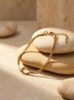 Model wearing an Eternity Knot Gold Bracelet on wrist