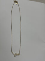 Close up of floral leaf necklace on black velvet display