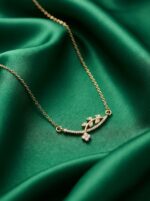 Minimalist gold plated necklace with delicate leaf and floral motif