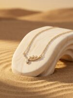 Minimalist gold plated necklace with delicate leaf and floral motif