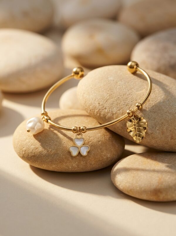 A woman wearing a stylish gold plated kada with a floral charm on her wrist