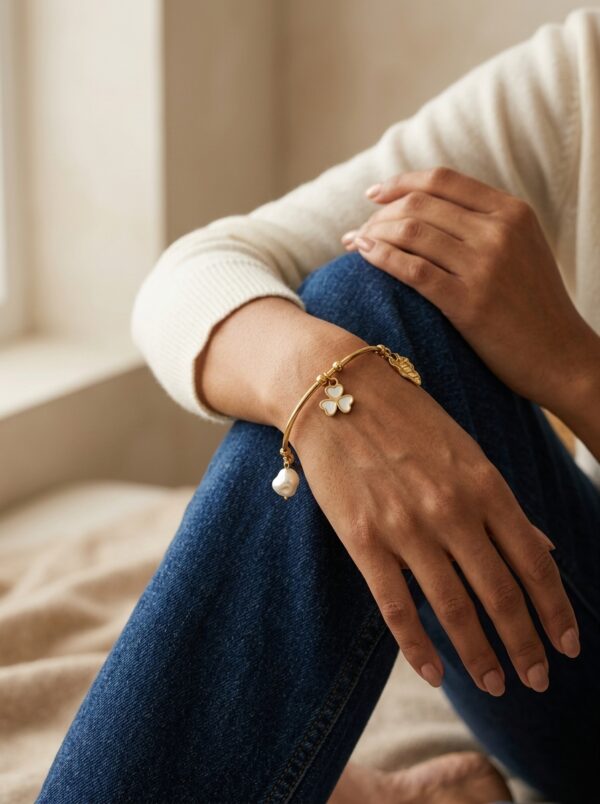 flora pearl gold plated kada gal 2 Elegant gold plated kada with a pearl and floral charm on a neutral background