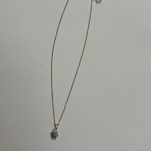 Close up of the Hamsa hand pendant detailing the blue and white stone inlay