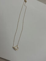 close up of gold plated necklace with crystals