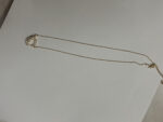 gold plated necklace with interlocking circles on white background