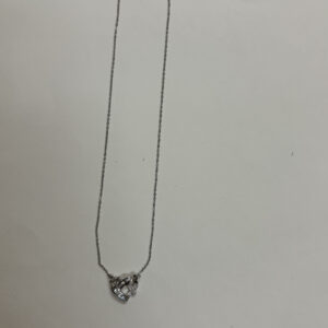 Studio shot of the Intertwined Heart Necklace on a soft cream background