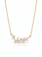 Studio shot of a gold plated necklace with a leaf charm on a white background