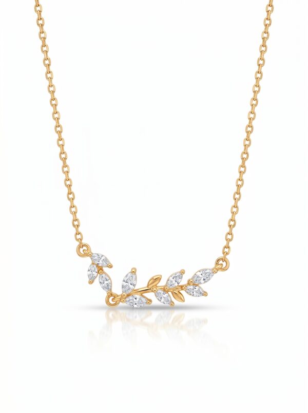 Studio shot of a gold plated necklace with a leaf charm on a white background