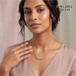 A delicate gold plated necklace featuring a leaf motif with sparkling marquise stones