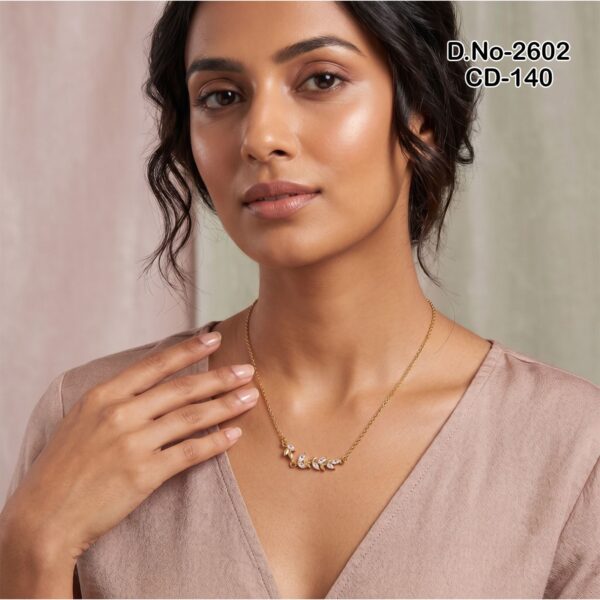 A delicate gold plated necklace featuring a leaf motif with sparkling marquise stones