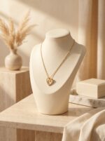 Close up of a sparkling gold plated heart necklace pendant