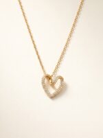 Woman wearing a delicate gold plated heart necklace