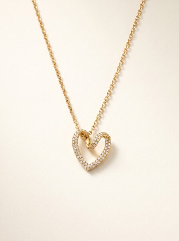 Woman wearing a delicate gold plated heart necklace