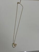 Lumina gold plated heart necklace on a jewelry display bust