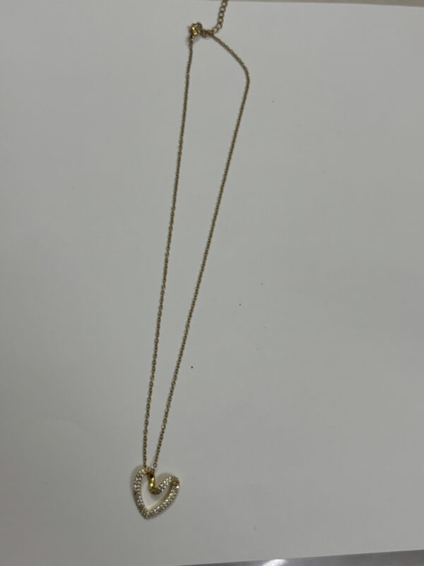 Lumina gold plated heart necklace on a jewelry display bust