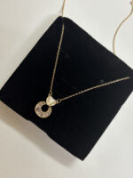 Full view of dainty gold heart pendant necklace on white background